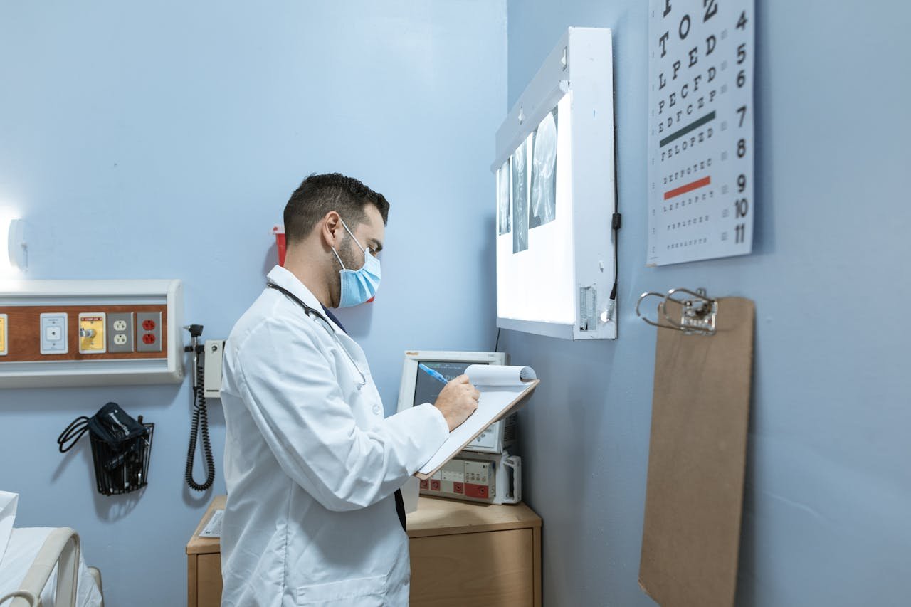 Offerings Medical expert analyzes X-ray in hospital room, highlighting healthcare professionalism.